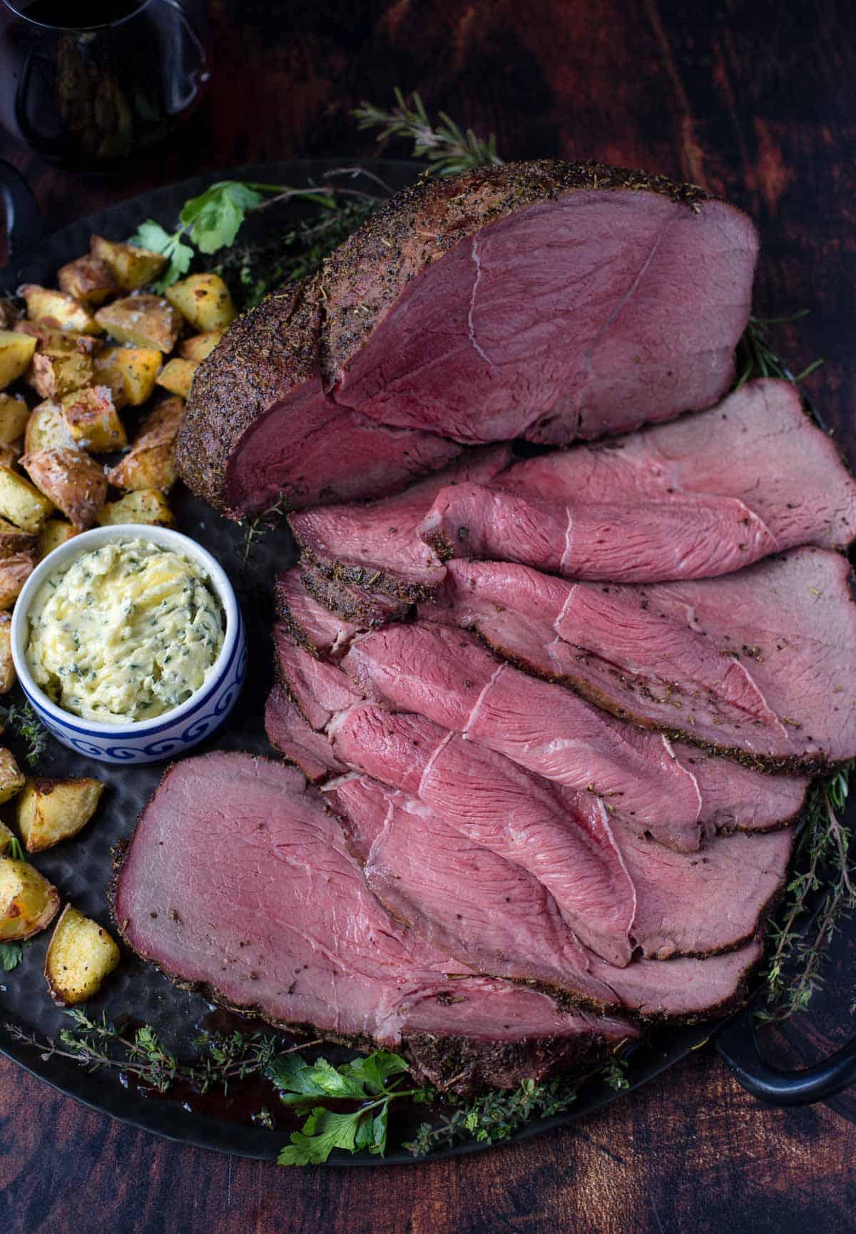Semplice Rosbif Affumicato alle Erbe 2 Arrosto di Controfiletto Affumicato su un piatto con patate.