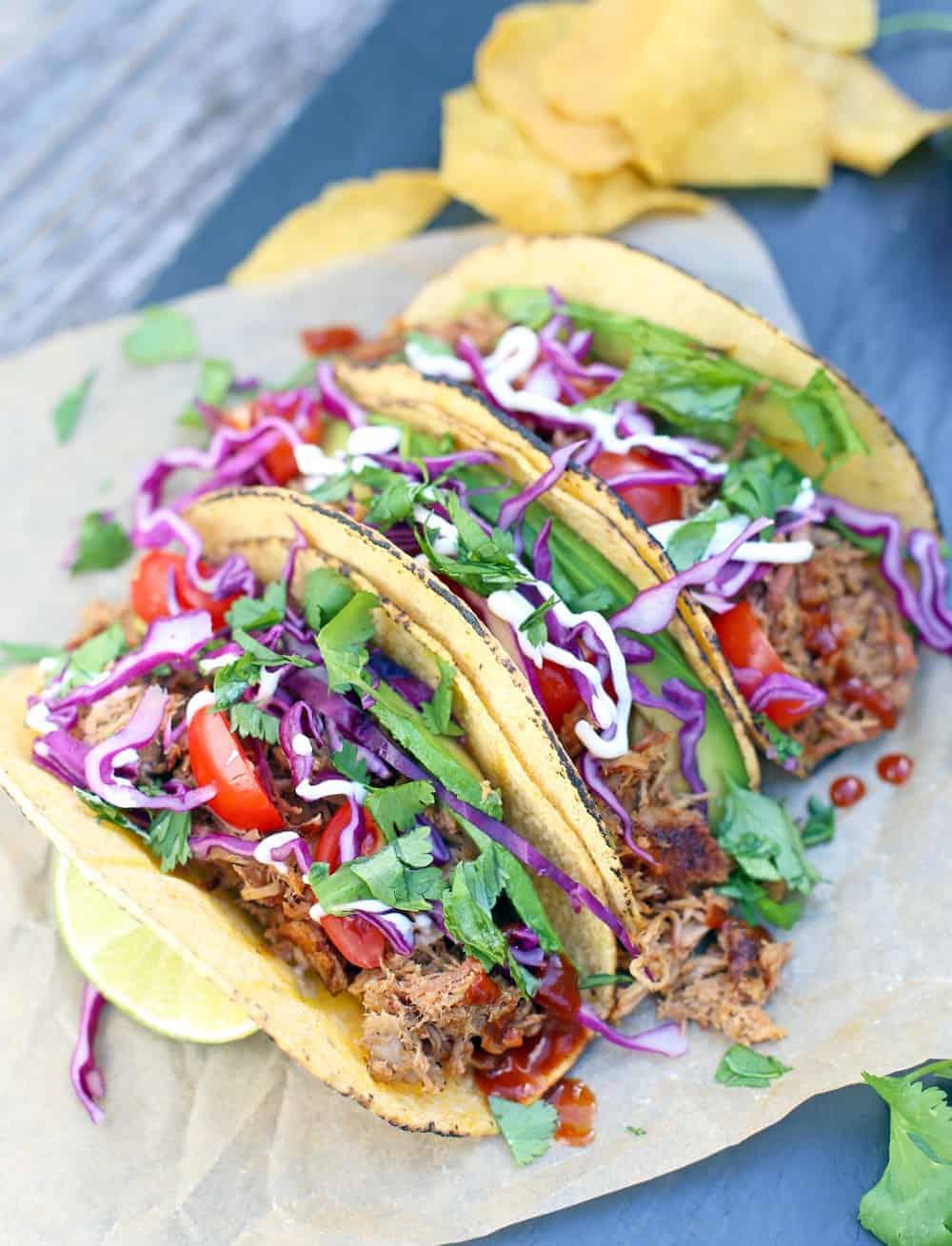 Tacos con Avanzi di Maiale Sfilacciato Affumicato 5 Tre Tacos di Maiale Sfilacciato su un piatto di portata.