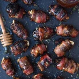 Datteri Avvolti nel Bacon Grigliati con Miele Affumicato 9 Datteri Farciti Avvolti nel Bacon Grigliati su un vassoio