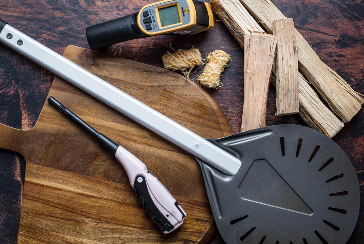 Recensione del Forno per Pizza Gozney Dome 4 Collezione di strumenti essenziali per la preparazione della pizza, tra cui pale e tagliapizza.