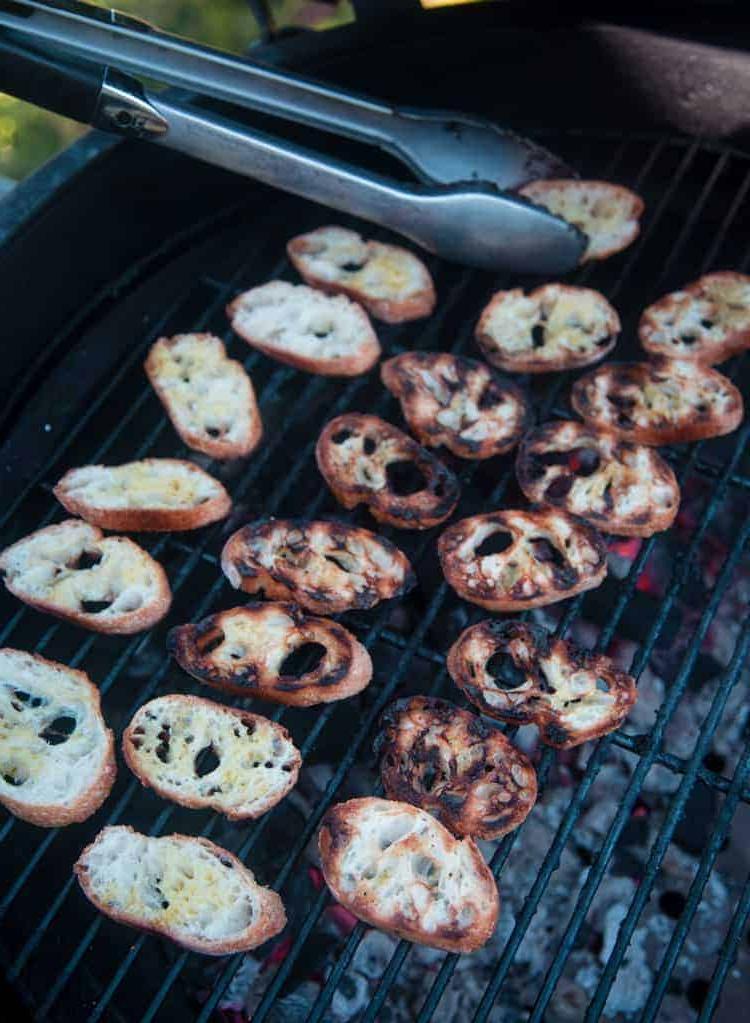 Crostini di Pesche Grigliate con Mascarpone e Miele 5 Fette di baguette che si tostano su una griglia.