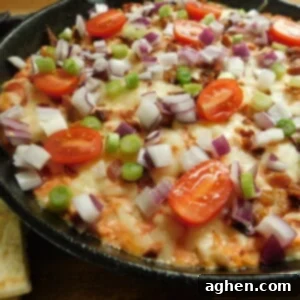 A serving of the Turkey Cheese Dip on a plate with chips