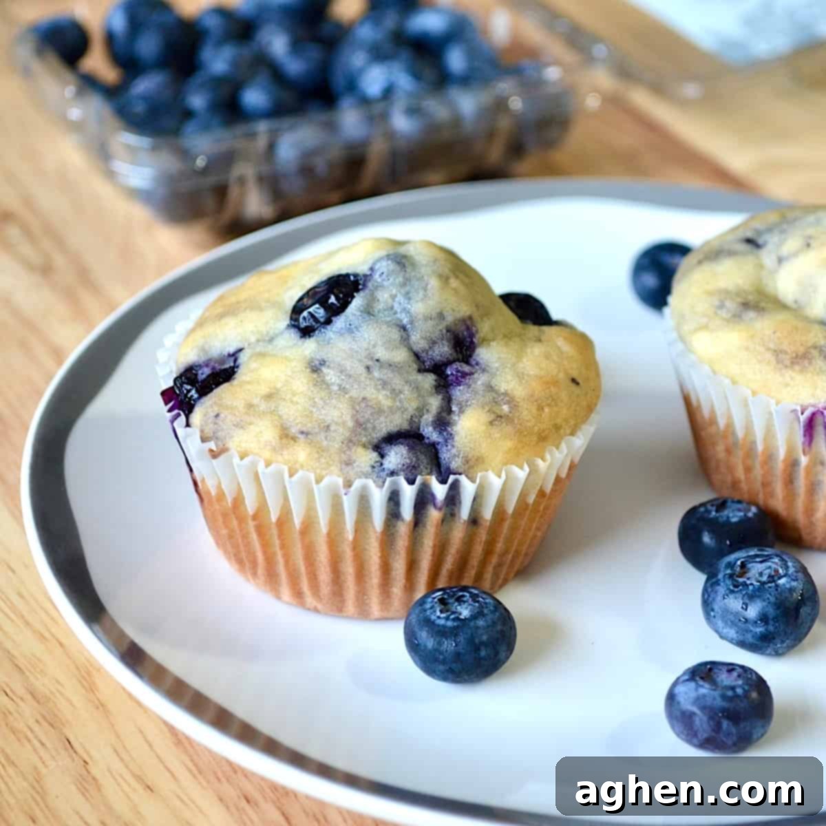 Blueberry muffins with carton of blueberries