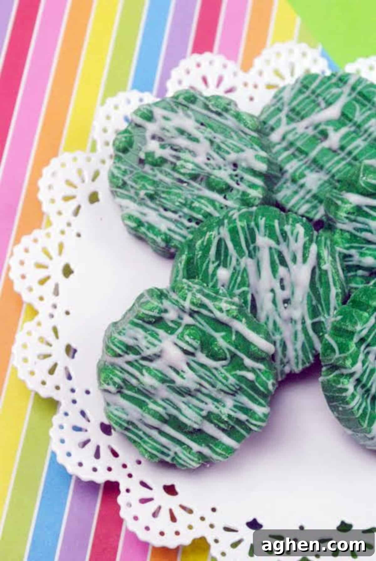 St. Patrick's Day Oreos 2 St. Patrick's Day Oreos dipped in green chocolate with a white chocolate drizzle on rainbow background.