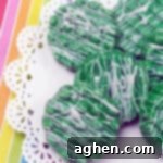 St. Patrick's Day Oreos 5 Candy-Dipped Green oreos with white chocolate drizzle on rainbow background.