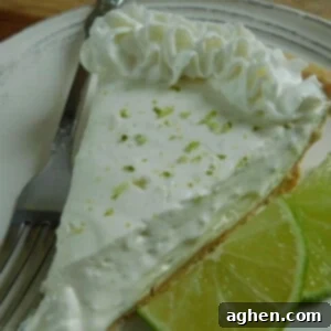 Zesty Key Lime Cheesecake 2 Close-up of a slice of Key Lime Cheesecake on a white plate