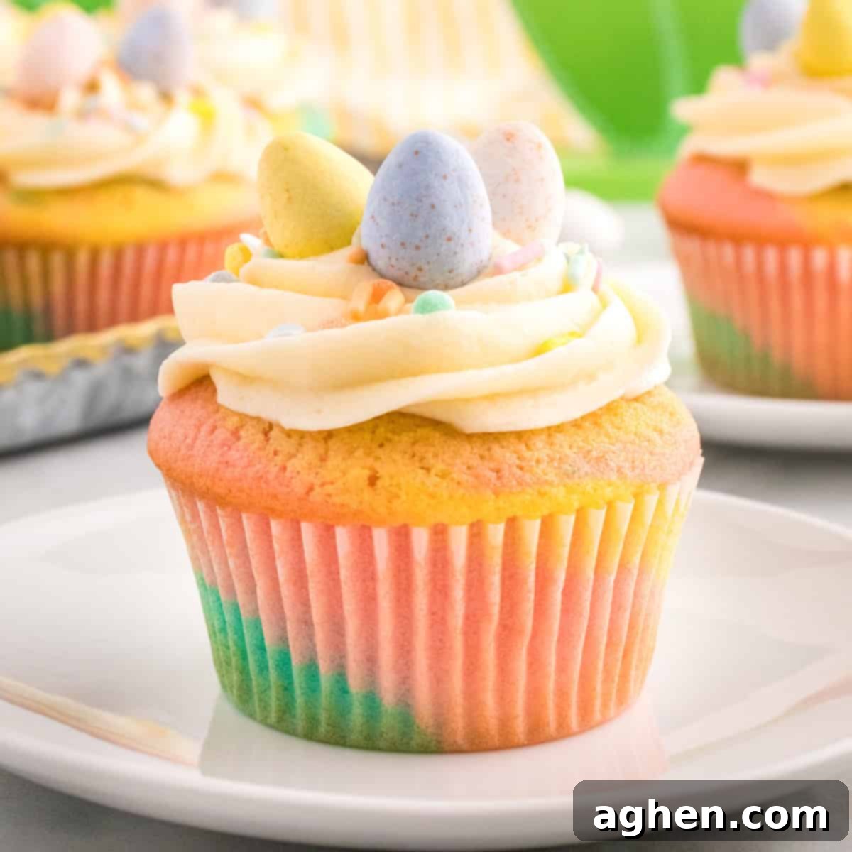 Pastel swirled easter cupcake topped with vanilla buttercream, sprinkles, and mini eggs.