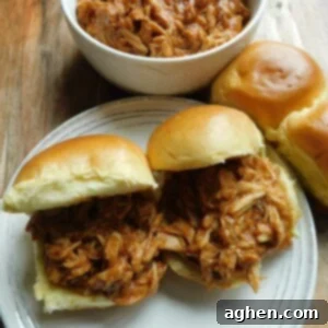 Effortless Slow Cooker Pulled BBQ Chicken 2 Pulled BBQ chicken sandwiches with sides, a perfect family meal