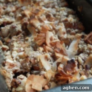 Nutty Apple Crisp 2 A serving of warm apple nut crisp, showcasing the layers of spiced apples and a crunchy topping.