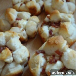 Close-up of a golden-brown Garlic Cream Cheese & Bacon Biscuit Muffin.