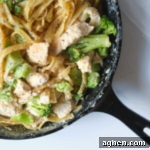 One-Pot Chicken Broccoli Fettuccine Alfredo in a black pan