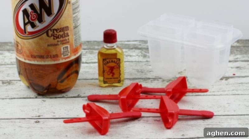 Fireball Cinnamon Roll Booze Pops 3 A&W Cream Soda 2 litter bottle, small Fireball Whiskey bottle, and 4 cavity ice pop mold.