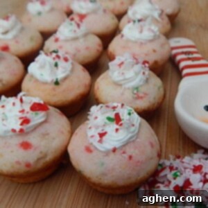 Close-up of a festive Candy Cane Mini Cupcake with frosting and sprinkles