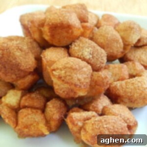 Mini Monkey Bread 2 A plate of freshly baked mini monkey bread muffins, with a rich golden-brown color and a visible sticky glaze.