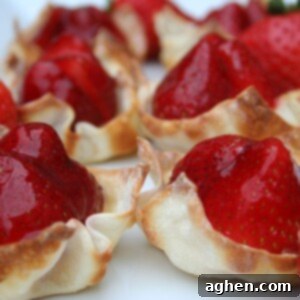 Close-up of a single strawberry custard tart, showcasing its vibrant colors and delicate texture.
