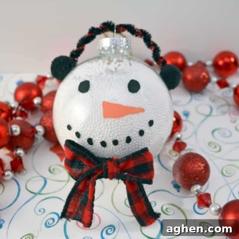 This handmade snowman Christmas ornament is fun and easy for the kids to make using clear plastic ball fillable ornaments.