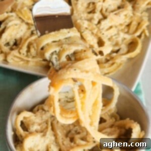 Fettuccini in a creamy zucchini sauce on a fork