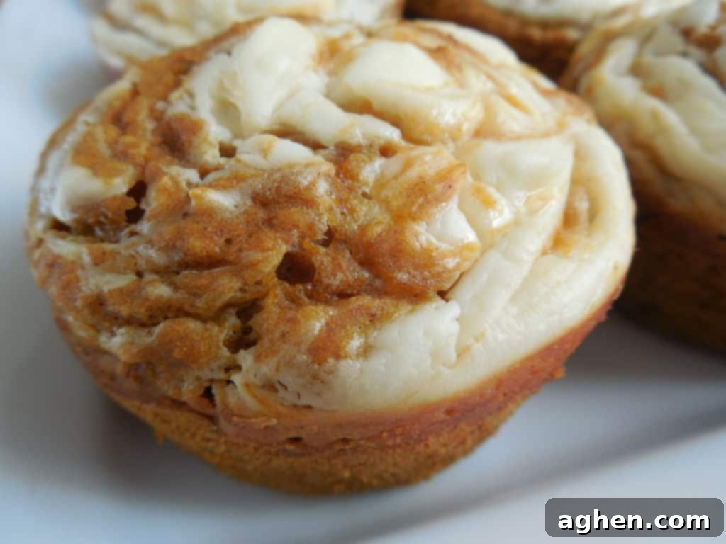 Pumpkin cream cheese muffin on white plate