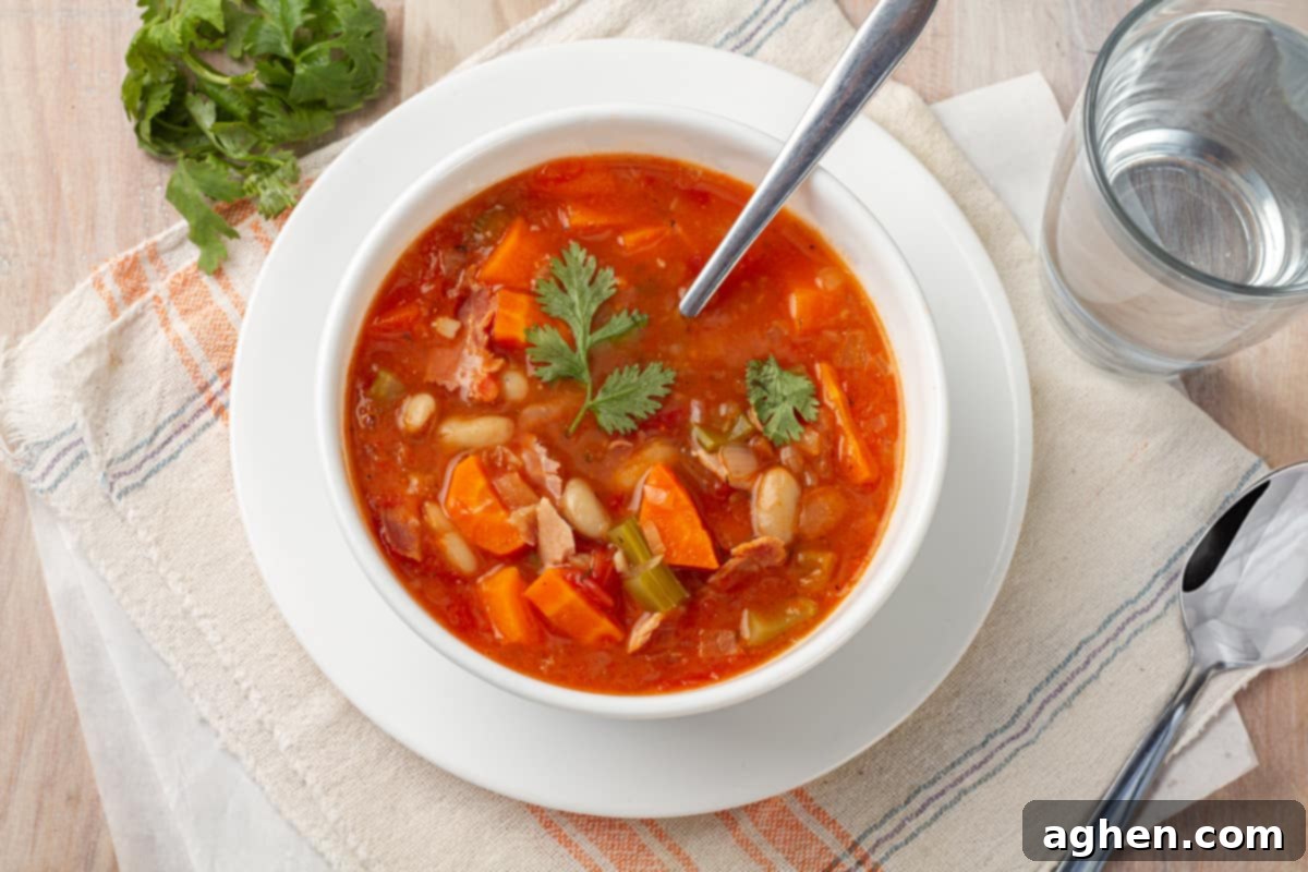 32 Delicious Weight Watchers Soups to Warm You Up This Fall 6 Ham and bean soup in a bowl with spoon.