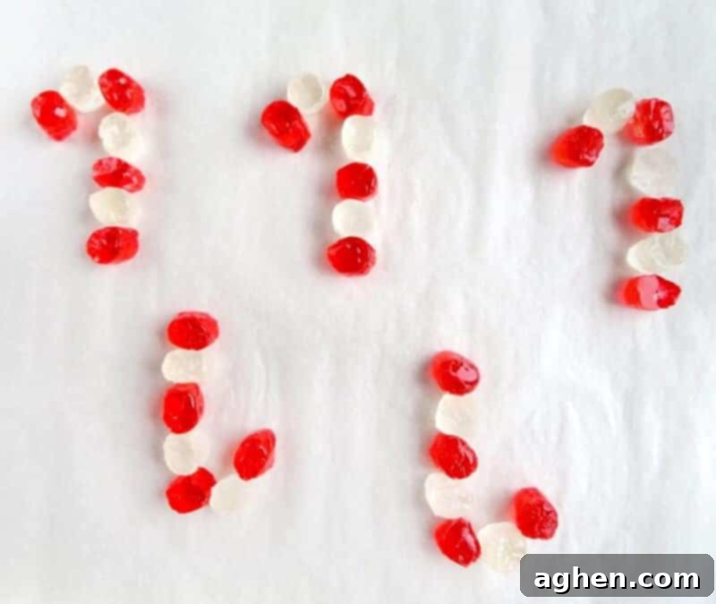 Cut jolly ranchers places on lined baking sheet in alternating red and white colors in shape of candy canes. 