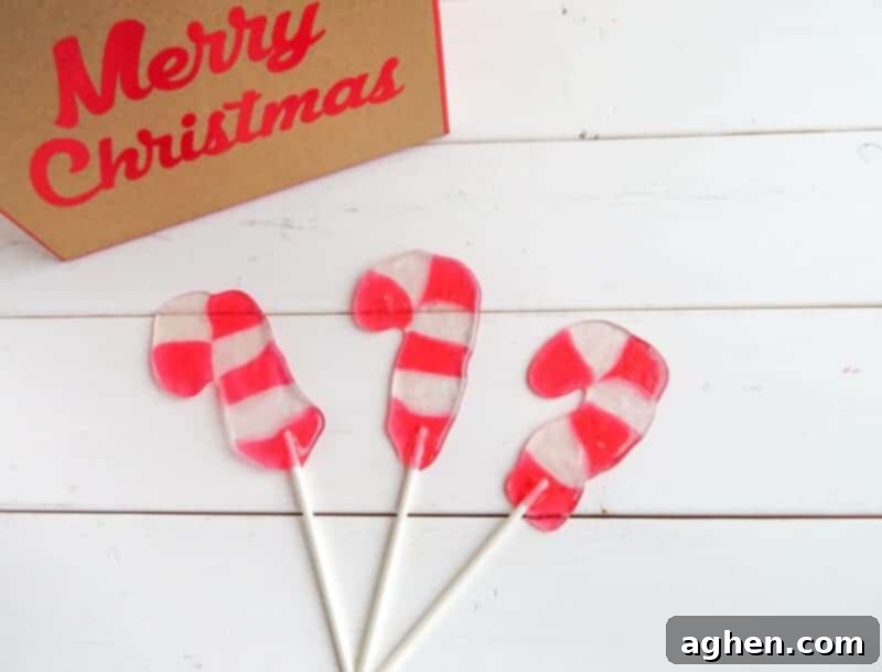 Candy Cane Suckers on white wood background.