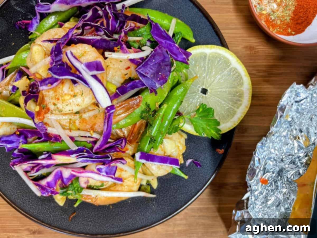 plate of weight watchers friendly snap pea and cabbage shrimp foil pack