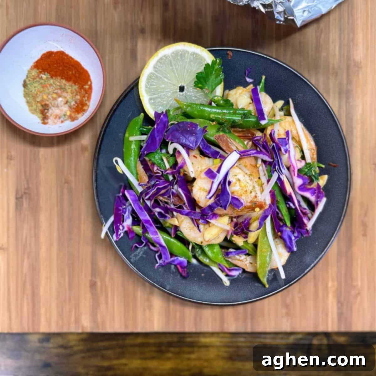 plate of weight watchers friendly snap pea and cabbage shrimp foil pack