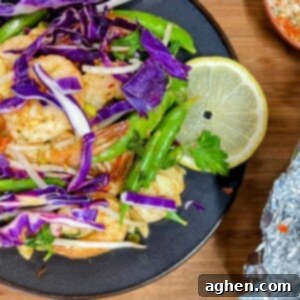 plate of weight watchers friendly snap pea and cabbage shrimp foil pack