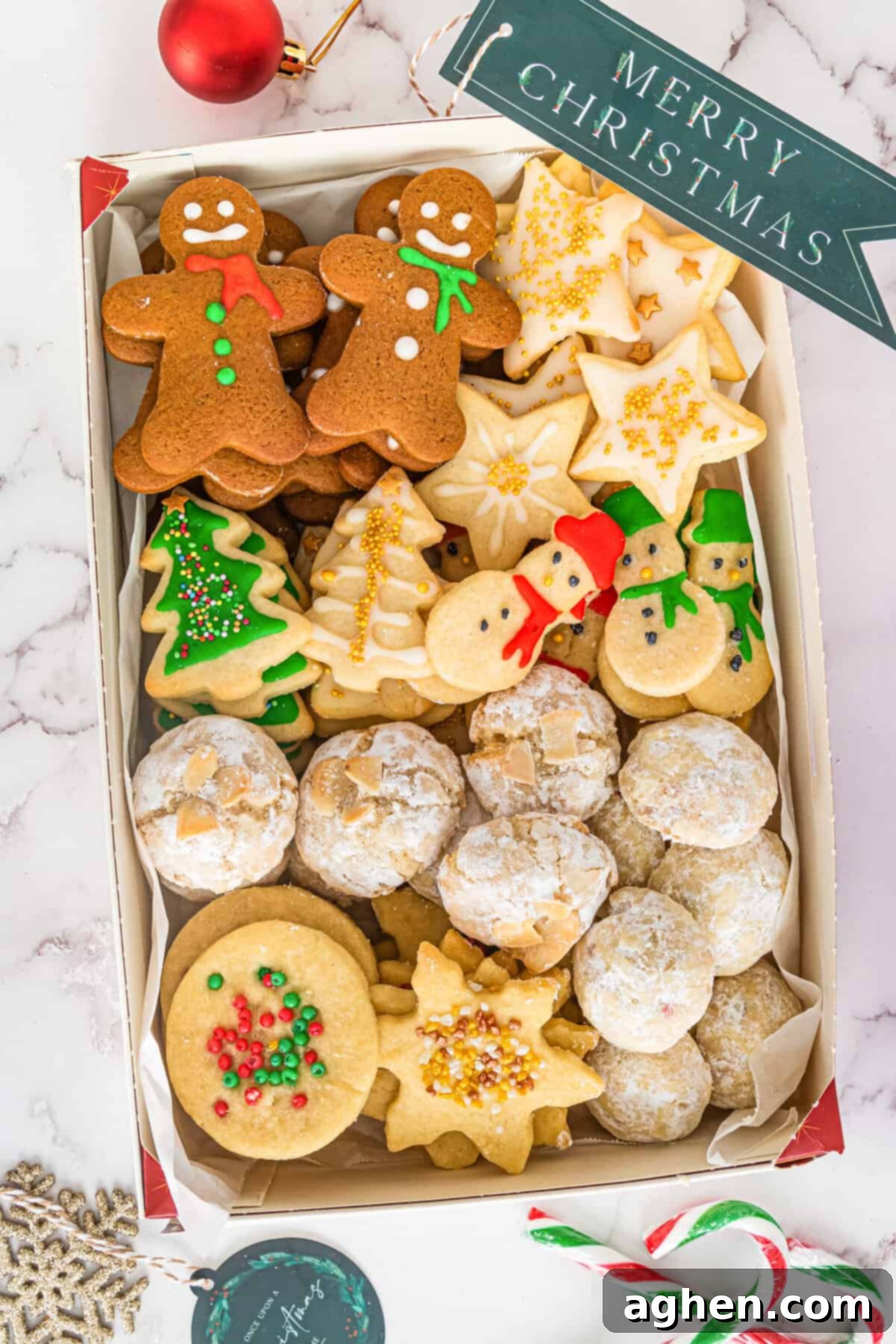 Gingerbread men, sugar cookies, shortbread, and snowballs boxed for a Christmas cookie exchange.