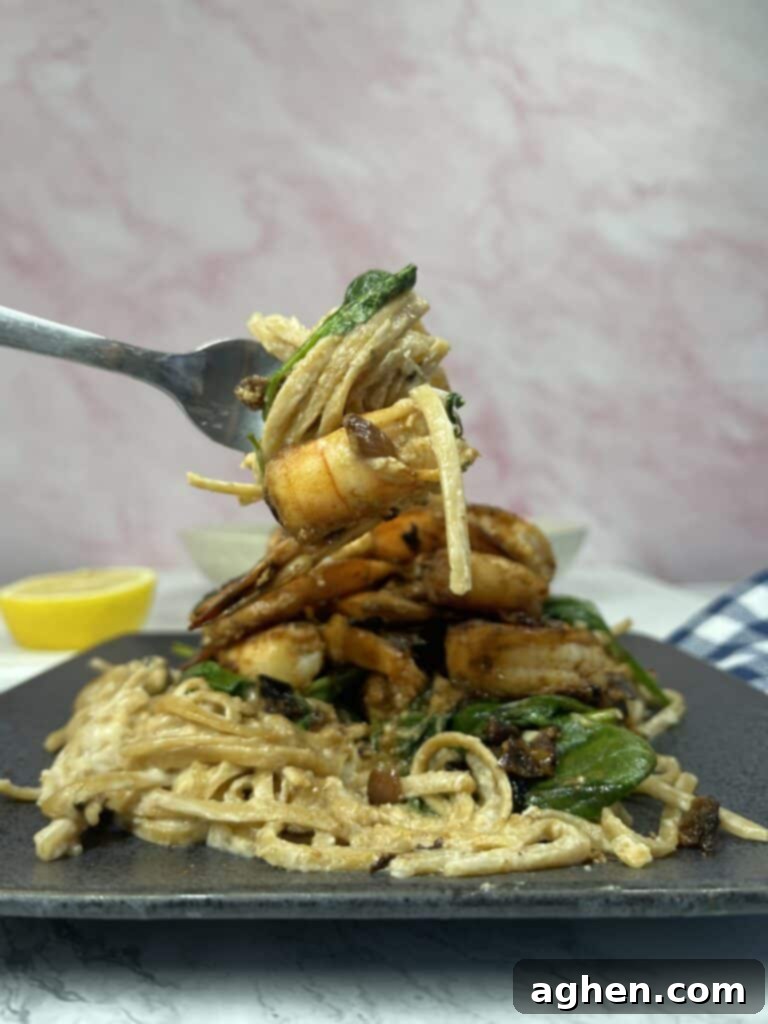 Creamy Weight Watchers Shrimp Alfredo with spinach on a fork