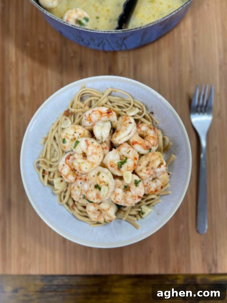 Shrimp scampi and linguine in a pasta bowl with a fork