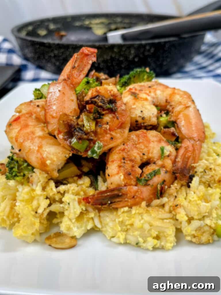 Delicious plate of shrimp fried rice with egg and vegetables