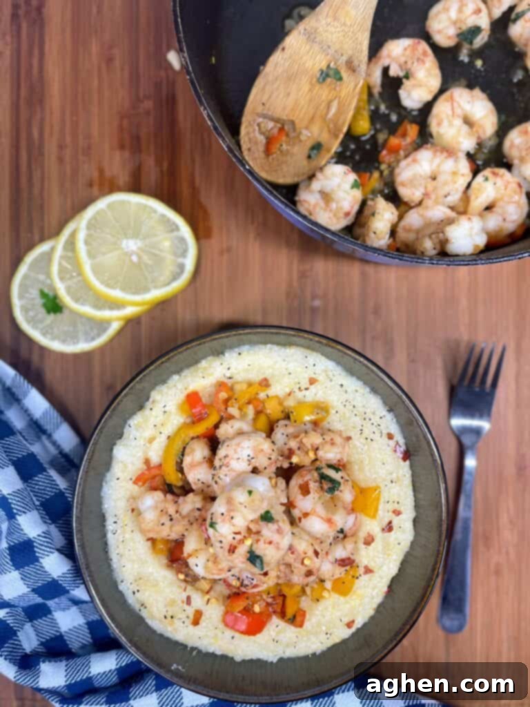 Bowl of creamy, cooked shrimp and grits with bell peppers