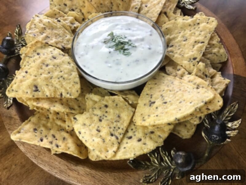 A close-up shot of the finished bacon ranch dip, richly textured and topped with vibrant chopped basil, ready to be enjoyed as a delightful appetizer.