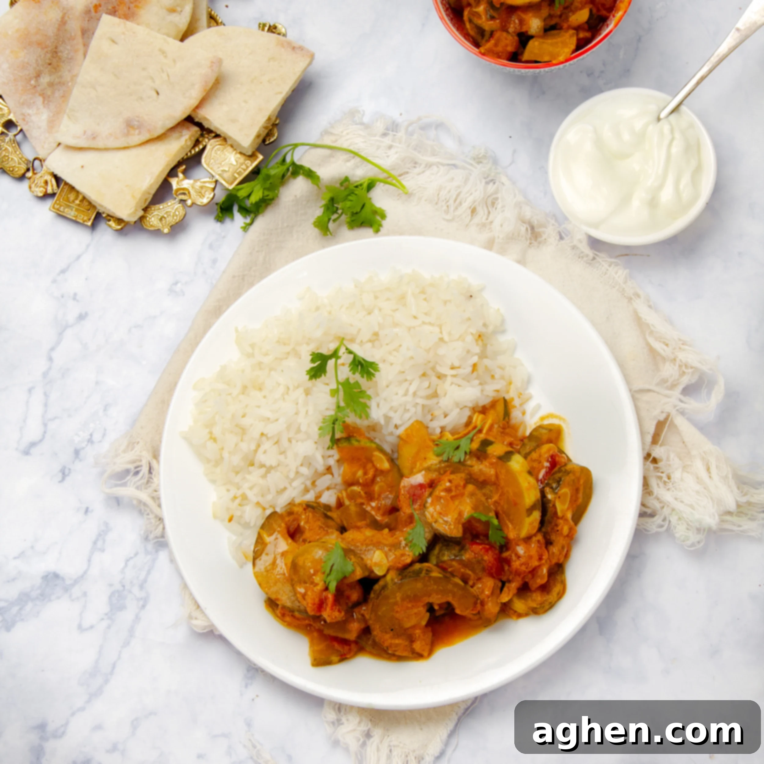 Scrumptious & Smart: 100 Weight Watchers Recipes 8 Vegan zucchini curry on a plate with rice and naan bread on the side.