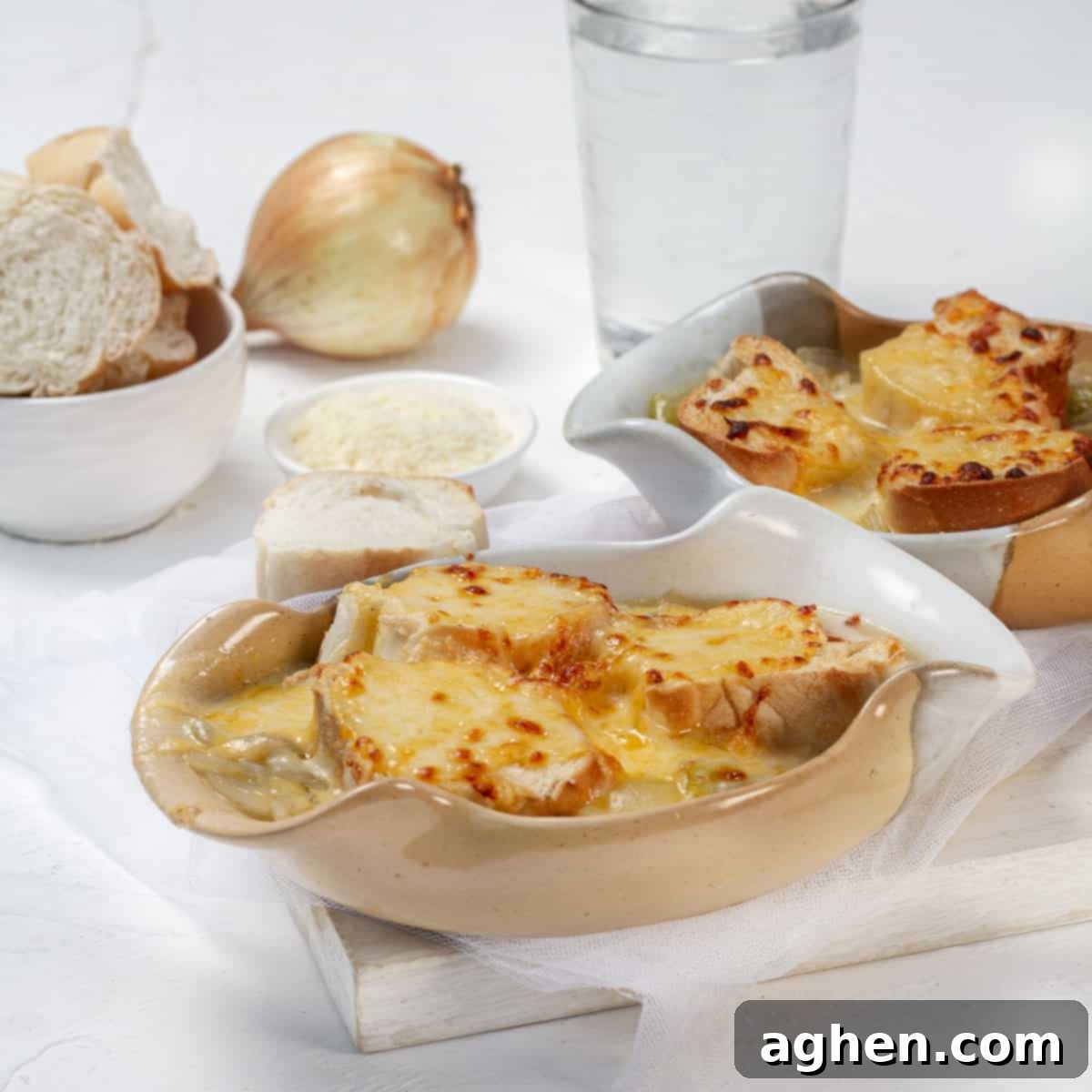 Scrumptious & Smart: 100 Weight Watchers Recipes 54 French onion soup in two bowls topped with bread and melted cheese.