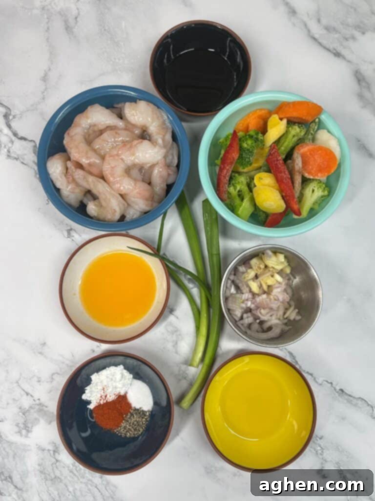 Fresh, raw ingredients for shrimp stir fry laid out on a cutting board