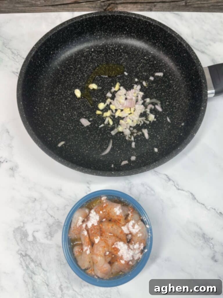 Sautéing garlic and shallots in a hot skillet for stir fry