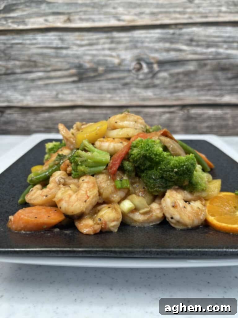 Top-down view of a generous serving of shrimp and vegetable stir fry with vibrant colors
