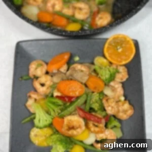 Quick and Healthy Weight Watchers Shrimp Stir Fry 8 cooked stir fry on plate with orange slice