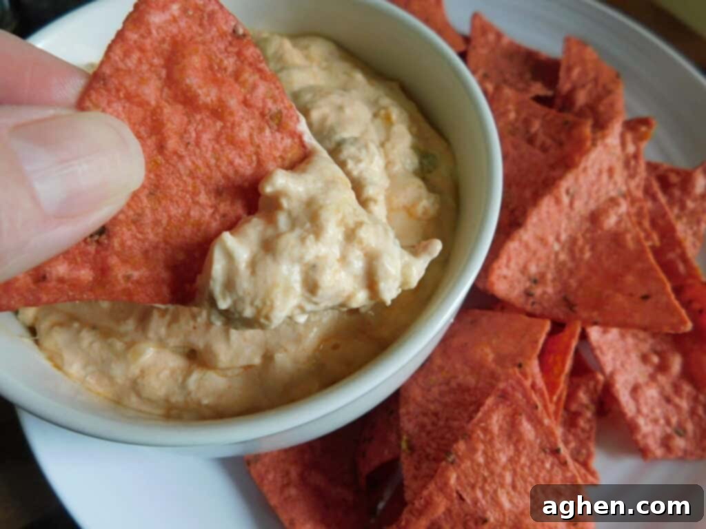 dipping chip into buffalo chicken dip