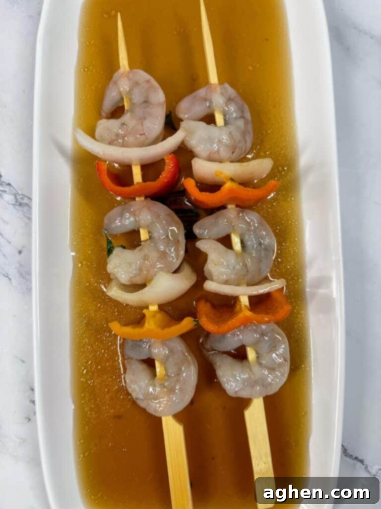 uncooked shrimp skewers in marinade