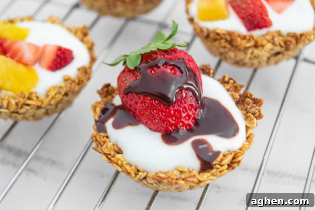 Oatmeal cup with yogurt, strawberry, and chocolate drizzle for a delicious and healthy treat