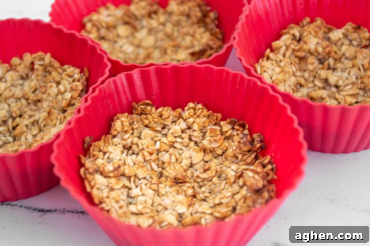 Ingredients for baked oatmeal cups arranged in muffin liners, ready for baking