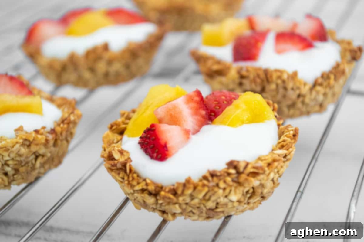 A baked oatmeal cup with a generous dollop of Greek yogurt and a vibrant assortment of fresh berries