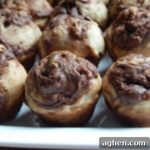 Swirled Banana Nutella Mini Muffins 2 Close-up of a mini banana Nutella muffin showing the swirl
