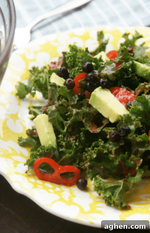 Blueberry Kale Salad with avocado, chili peppers, and a raspberry lime vinaigrette.