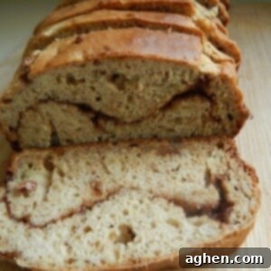 A slice of banana cinnamon swirl loaf, showing the beautiful cinnamon ribbon.