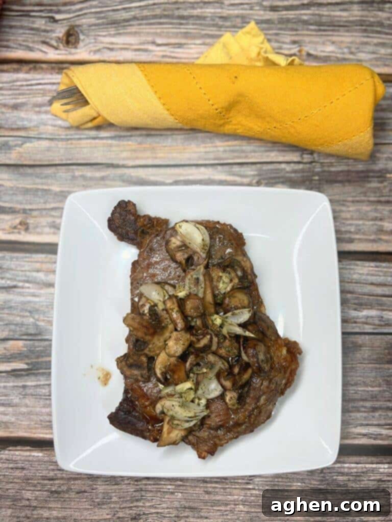 cooked air fryer ribeye steak with mushrooms, perfectly seared and juicy