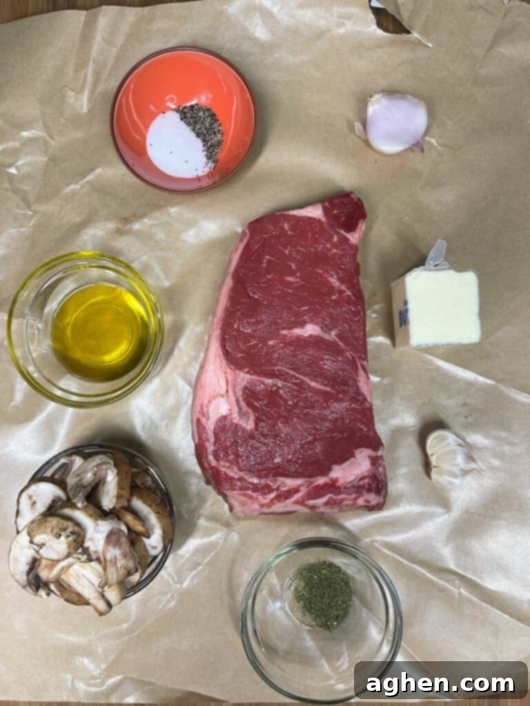 Ingredients for air fryer ribeye steak with sautéed mushrooms, including fresh mushrooms, shallots, garlic, and dill